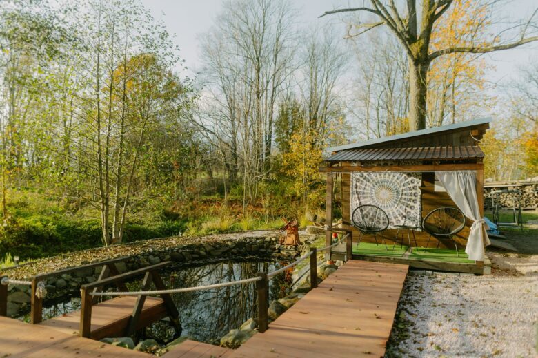 Wooden deck leading to a serene pond at Bohemian Homes, Bohemian Switzerland, Czech Republic.