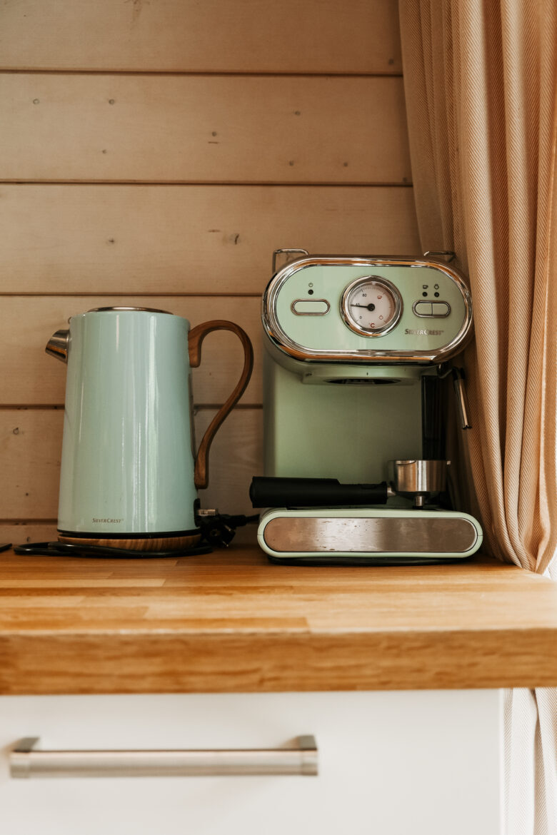 Coffee maker and kettle on wooden countertop at Bohemian Homes.