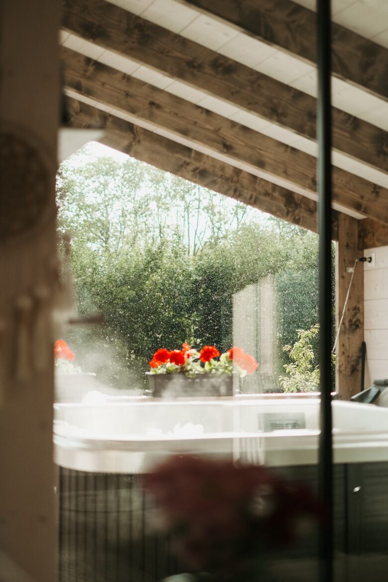Jacuzzi with flowers, surrounded by greenery at Bohemian Homes.